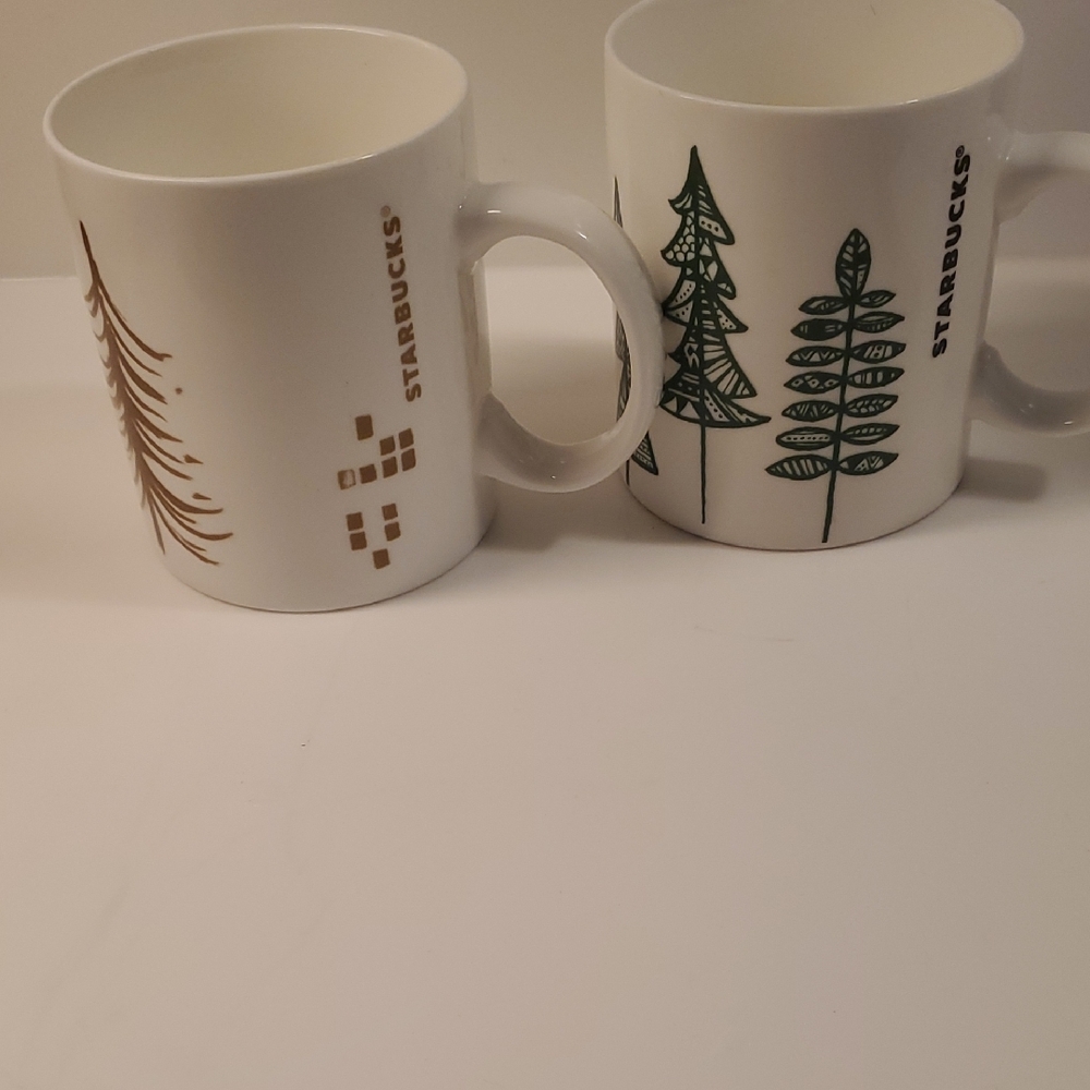 Starbucks White Mugs with Green and Gold Tree Designs 2-mugs. 12oz.